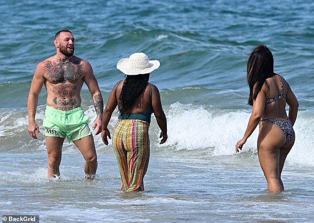 He made his way to cool off in the ocean with the woman and another female friend