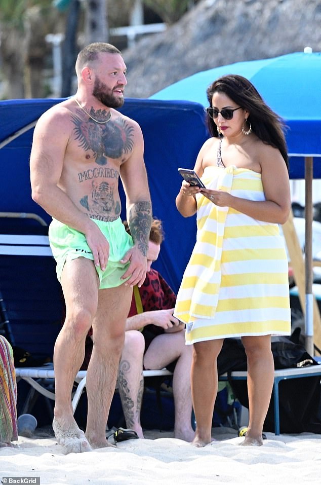 McGregor's girl later covered up in a yellow and white stripe towel