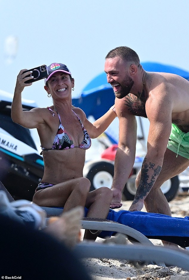 Elsewhere he posed for selfies with fans on the beach