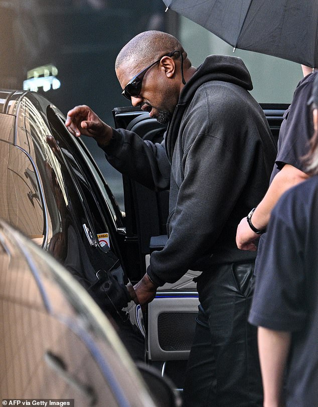 Kanye was photographed getting into a car after arriving at Shanghai Pudong International Airport on July 11