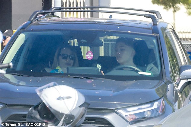 Angelina looked glamorous in a pair of glossy black sunglasses with her blonde hair ironed straight and falling around her face