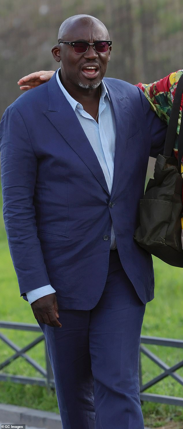 Edward Enninful cut a sophisticated look in a navy blue two-piece suit which he layered over a pale blue shirt