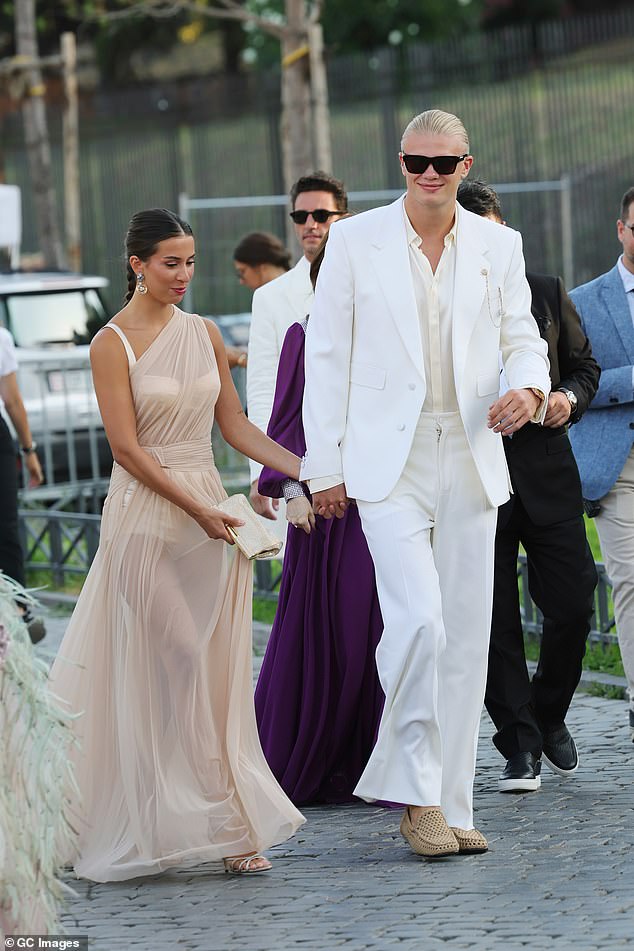 He finished his striking ensemble with a pair of brown suede loafers and a pair of bold black sunglasses