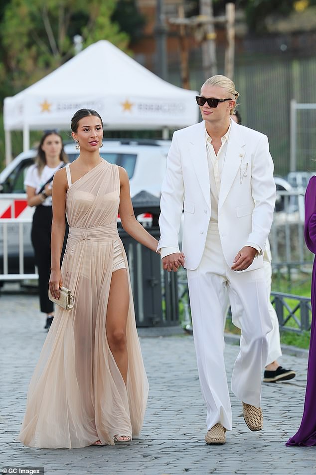He finished his striking ensemble with a pair of brown suede loafers and a pair of bold black sunglasses