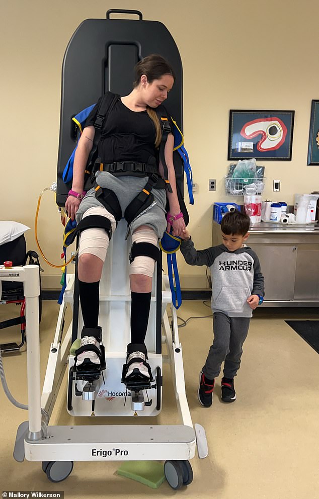 Pictured: Beckham mimics his mother 'stepping' during one of her many physical therapy sessions to regain her ability to walk