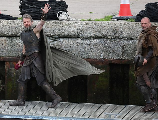 The Hollywood actor waved to fans and photographers in between filming