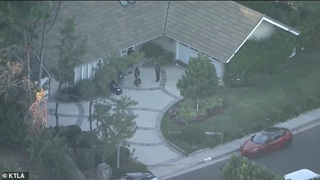 Police are seen searching the $2.5 million six bedroom house where the Haskells lived with Mei's parents shortly after their disappearance