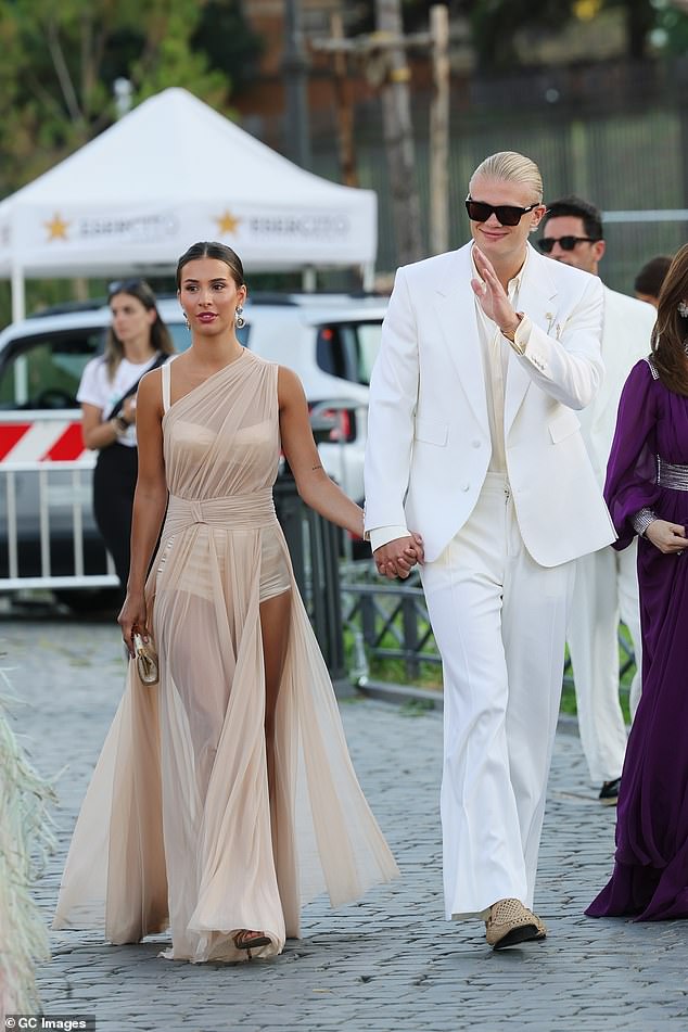 Haaland waved as he and Johansen were seen arriving at the show in the Italian capital
