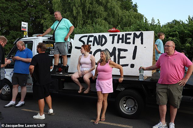 Some people arrived outside the migrant hotel with signs saying 'send them home'