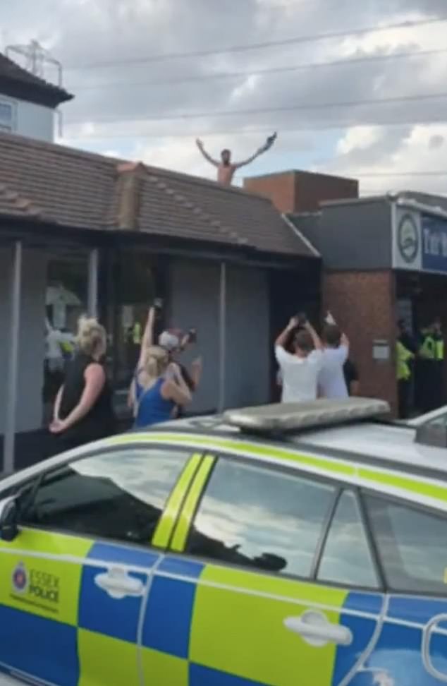 One man appeared to have climbed on top of the hotel's roof during the protest on Sunday