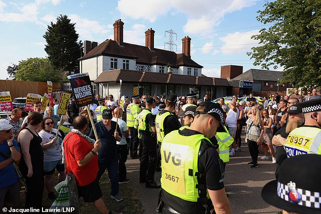 Police officers separate 'anti-racism' demonstrators from others protesting at the scene