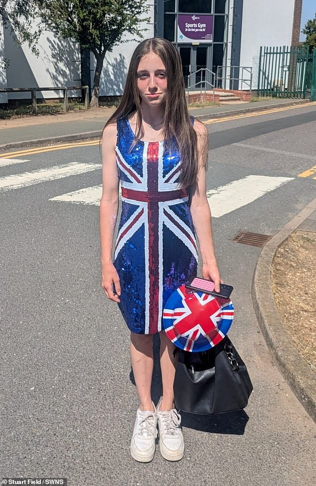 Courtney poses for a photo showing her costume after being made to leave school on culture day