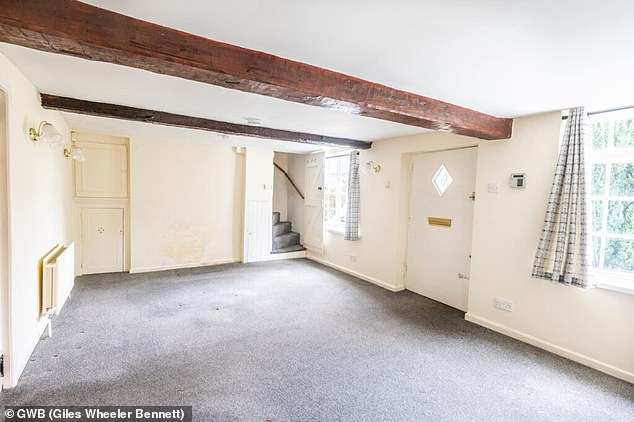 The home boasted an open plan living space with wooden ceiling beams, bay windows and built-in cupboards