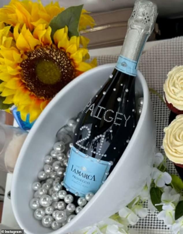 One of Paige's crewmates shared a photo of a bottle of prosecco emblazoned with her nickname 'Paigey' and 21