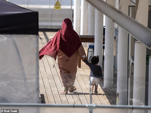 An Afghan woman and her child go for a walk in the Berkshire sunshine