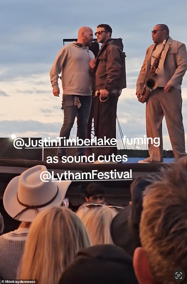 Several stage hands approached the singer