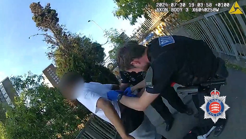 Lucas Braga, 18, of the Northside gang, has a wound on his back checked as he is arrested. The police officers took him to hospital as an ambulance wasn't available. A Southside member was airlifted to hospital with serious chest injuries.