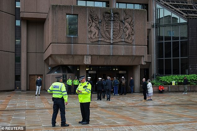 Police officers stand outside the entrance of the Liverpool Magistrates' Court on May 30 when Doyle previously appeared