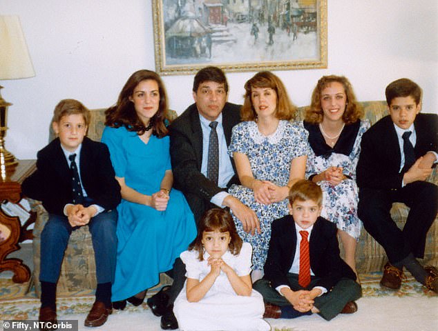 Pictured: Robert and Bonnie Hanssen (top center) with their six children, photographed in the early 1990s before his arrest