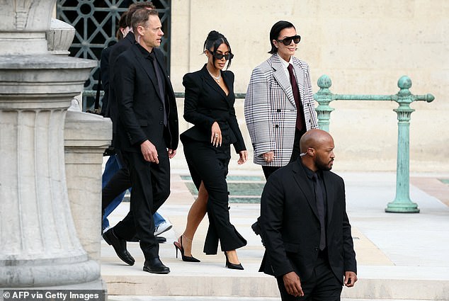 Kim Kardashian (pictured above with mom Kris Jenner and security guards) said she blamed herself for the terrifying armed robbery in Paris in 2016, and vowed to stop flaunting her wealth on social media