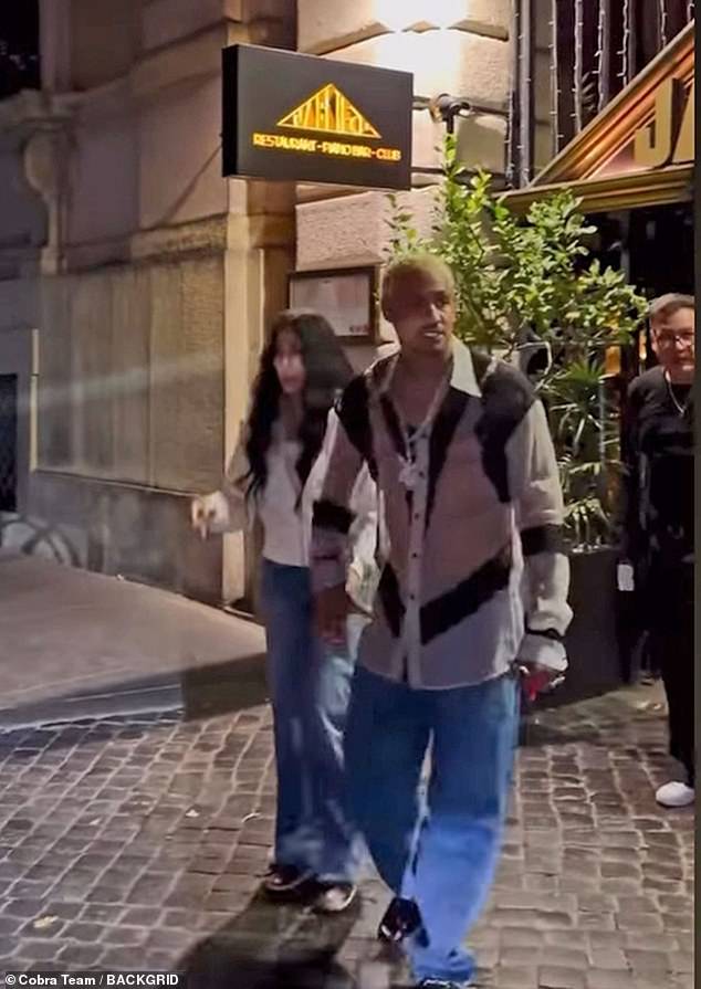 Cher looked relaxed wearing a white jacket and a pair of straight leg jeans with black and white sneakers. Edwards, 39, looked dapper in a long white and black animal print shirt over a pair of straight leg jeans and dark shoes