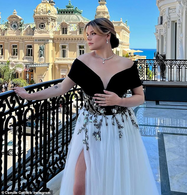 Camille’s modernized take paid homage while adding her own flair, featuring sparkling silver floral embellishments across the bodice and a daring thigh-high slit