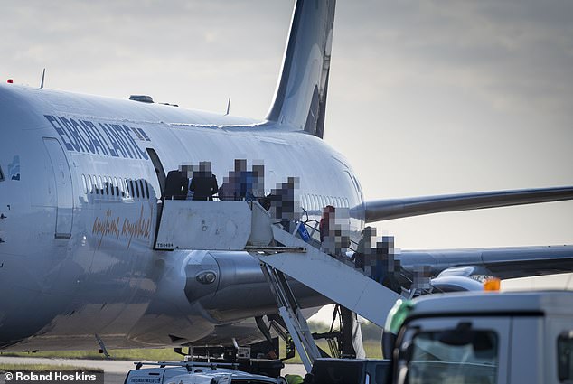 Hundreds of migrants file off a taxpayer-chartered jet