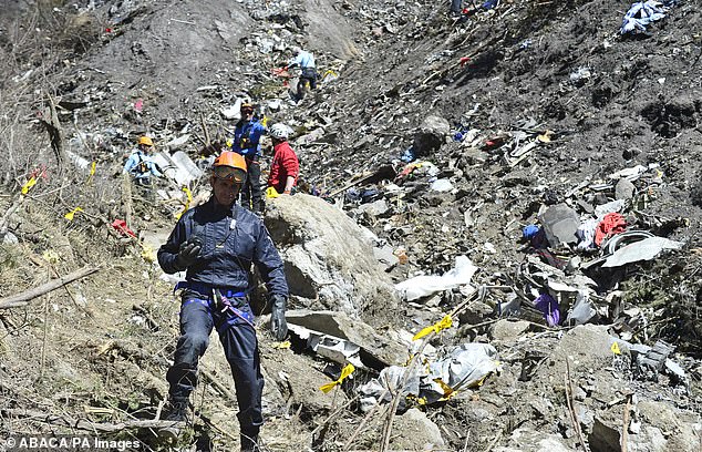 Rescuers search for human remains at the Germanwings crash site on March 26, 2015
