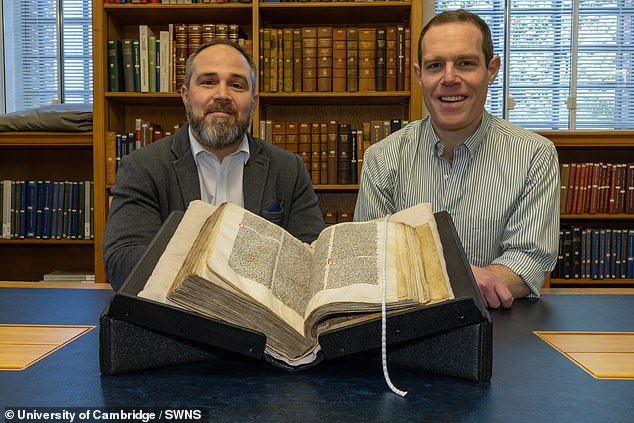 James Wade (left) and Seb Falk (right) with Peterhouse MS 255 open at the sermon