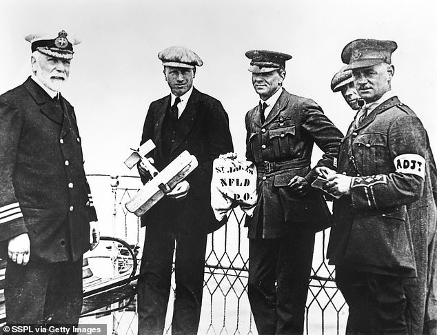 Alcock (centre left) holds a model of their Vickers Vimy biplane, and Brown (centre right) holds a mailbag