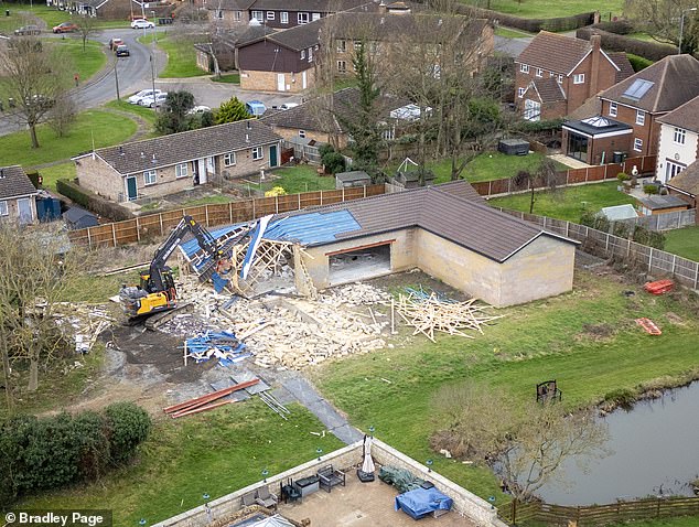 Pictures show a demolition excavator tearing down the property