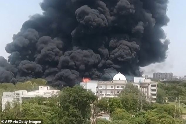 This screengrab from UGC video footage shows thick black smoke billowing from a residential area after Air India flight AI171 crashed in Ahmedabad on June 12, 2025
