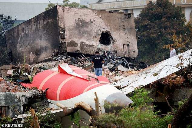 The diversion comes after a report into the Air India tragedy found that fuel switches for the engines of the doomed plane. FILE PHOTO: A firefighter stands next to the crashed Air India Boeing 787-8 Dreamliner in Ahmedabad on June 13