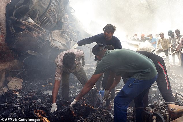 scue officials work at the site where Air India flight 171 crashed in a residential area near the airport in Ahmedabad on June 12