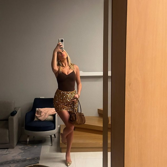 Phoebe shared a photo of one of her holiday outfits in Dubai, as she modelled a sparkly gold skirt with a black bodysuit, in a post on Instagram