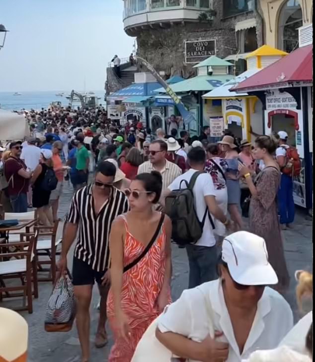 She wrote: 'I was expecting all of the stairs, but I wasn't expecting the magnitude of the crowds and the lineups.' Pictured: The crowds in Positano