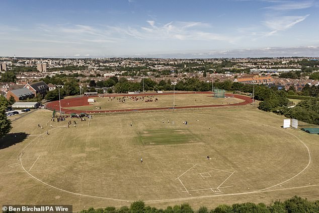 Wilting cricket creases are surrounded by parched grass at a sports ground in Bristol last week