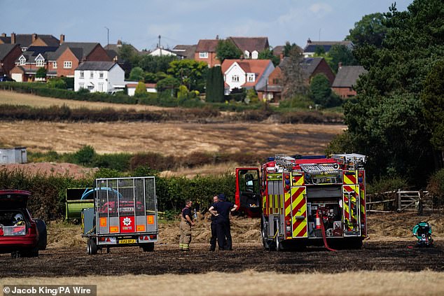 Firefighters at a field in Marlbrook, Worcestershire, following a wildfire on Saturday evening