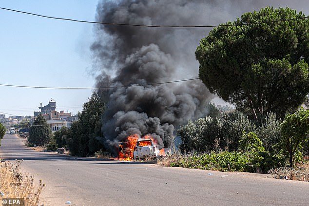 A vehicle ablaze amid ongoing clashes in the southern city of Sweida, 16 July 2025