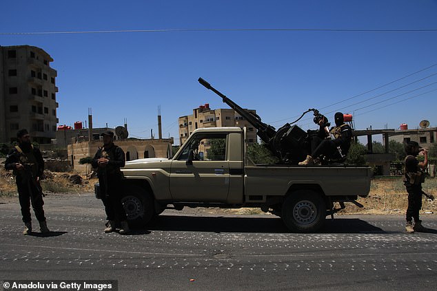 Syrian Defense Ministry military units are seen with military vehicles entering the city to control the situation after three days of clashes in Suwayda, Syria on July 15