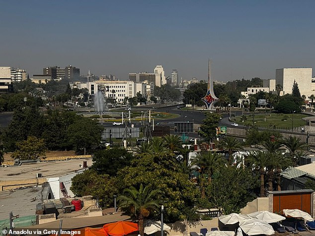 Emergency services arrive and set up a security perimeter following an Israeli airstrike targeting the entrance of the Syrian army's General Staff Complex in Damascus, on July 16