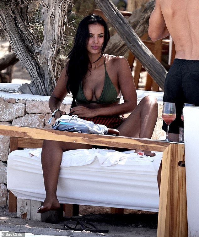 The presenter slipped into a plunging green bikini as she enjoyed the romantic getaway