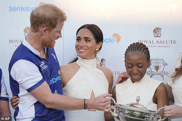 An awkward moment at a polo match last year, which saw Meghan seemingly direct Dr Chandauka (right), the chairwoman of Harry's charity Sentebale, to move away from the prince