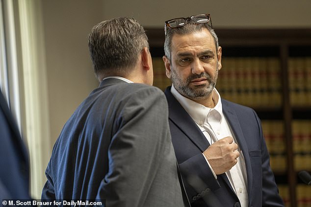 Ihsan (right) speaks with his lawyer Erik Kaeding in court on Wednesday