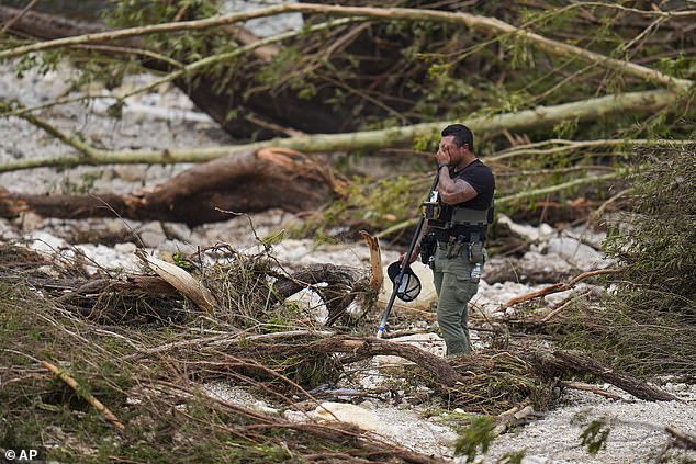 A first responder appears emotional amid the search for bodies and survivors in Texas