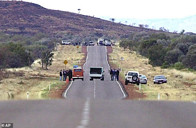 Police investigate the sight of the ambush, with the couple's orange VW Kombi van seen at the side of the road, just as they left it that night