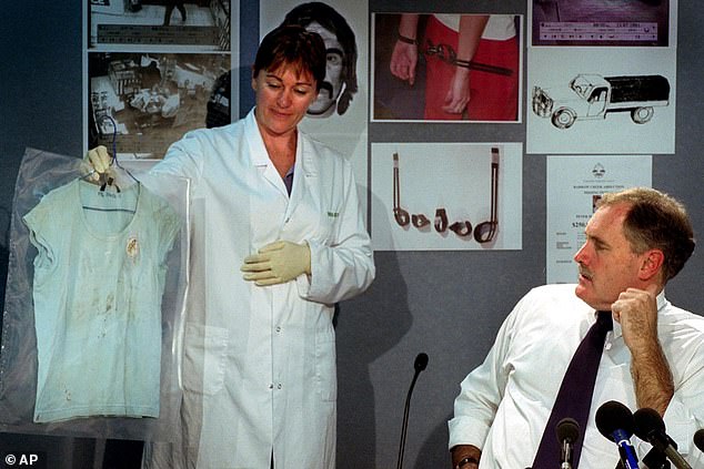 Senior police biologist Kamen Eckoff with the T-shirt Joanne wore on the night Peter was abducted in2001