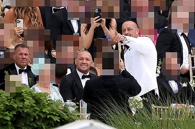 McGregor (centre) is pictured at a family wedding with Whelan (left)