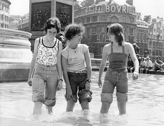 Women enjoy the cooling water in the fountain at Trafalgar Square