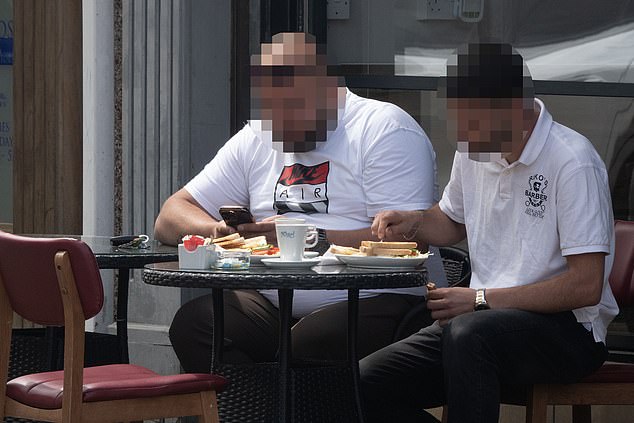 Two friends tuck into a full English breakfast outside a café in Ebbw Vale